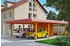 Skan Holz Doppelcarport Wendland 630x879 cm 216 cm Einfahrtshöhe mit Abstellraum mit EPDM-Dach rote Blende Eiche hell