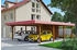Skan Holz Doppelcarport Wendland 630x879 cm 216 cm Einfahrtshöhe mit Abstellraum mit Aluminiumdach rote Blende Nussbaum