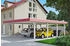 Skan Holz Doppelcarport Wendland 630x879 cm 216 cm Einfahrtshöhe mit EPDM-Dach rote Blende Weiß