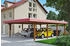 Skan Holz Doppelcarport Wendland 630x879 cm 216 cm Einfahrtshöhe mit EPDM-Dach rote Blende Nussbaum